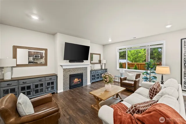 a living room with fireplace furniture and a flat screen tv