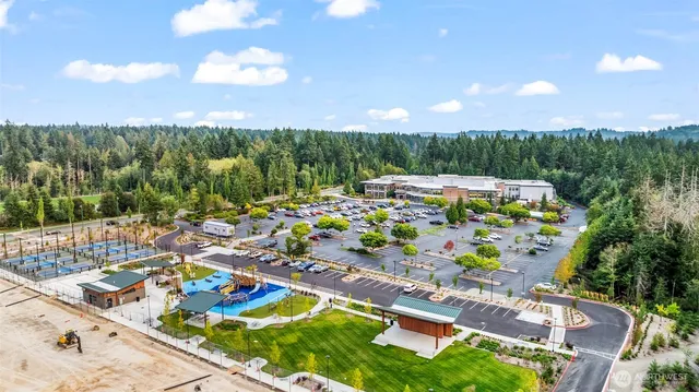 an aerial view of residential house with outdoor space and trees