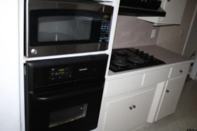 a close view of a stove and microwave