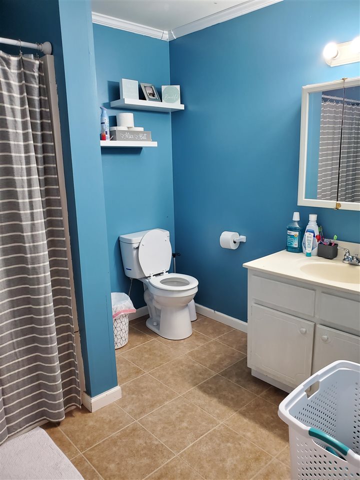 39 Clark Lane Ripley, TN 38063 - Photo 7 of 10 a bathroom with a toilet a sink and a mirror