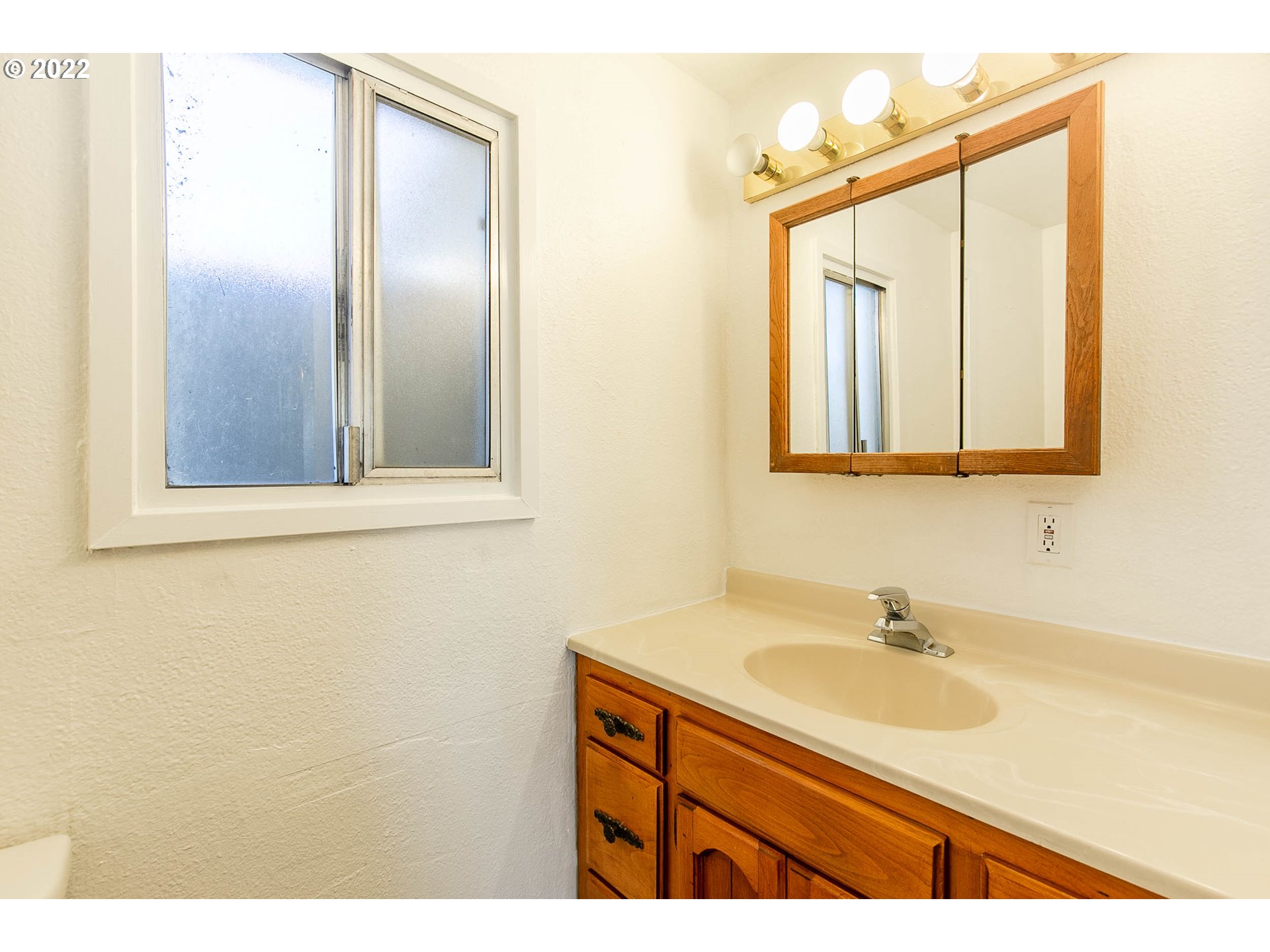 1158 D Street Springfield, OR 97477 - Photo 16 of 24 a bathroom with a sink and a mirror