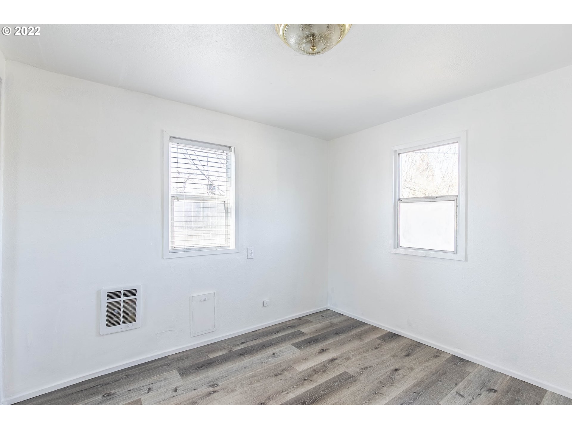 1158 D Street Springfield, OR 97477 - Photo 17 of 24 an empty room with wooden floor and windows