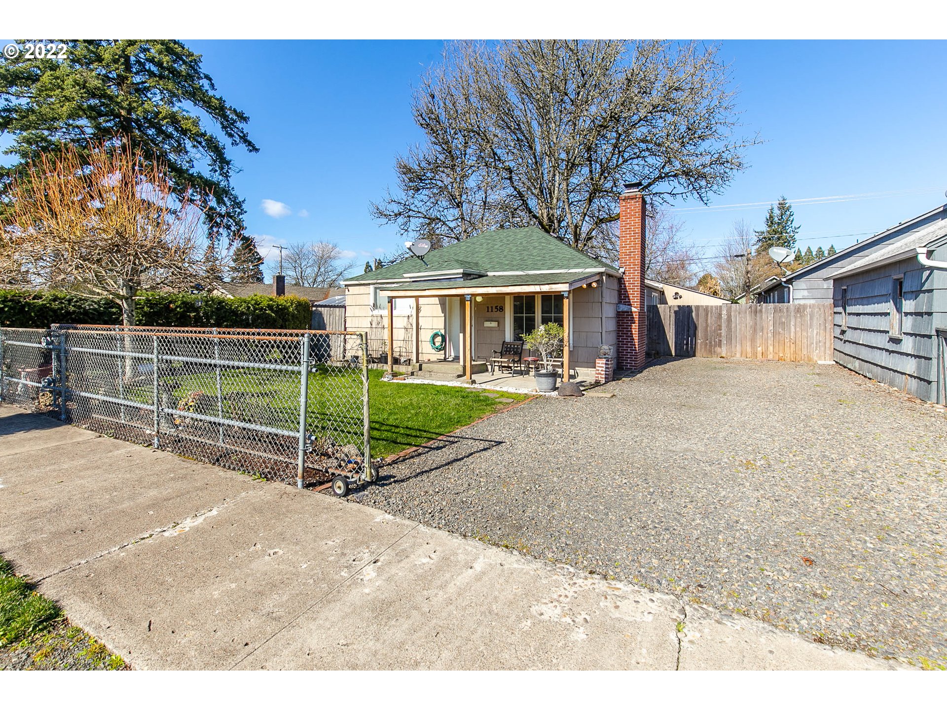 1158 D Street Springfield, OR 97477 - Photo 2 of 24 a view of a house with backyard and trees