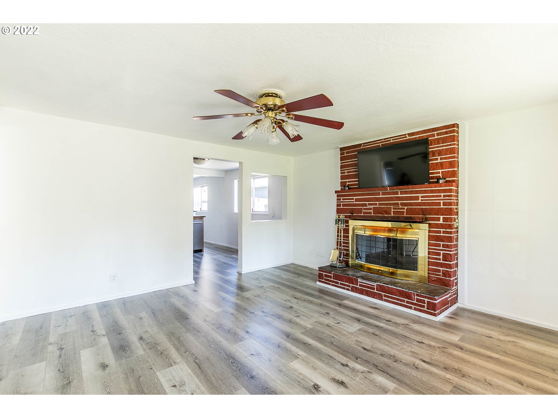 1158 D Street Springfield, OR 97477 - Photo 3 of 24 a view of an empty room with wooden floor and a fireplace