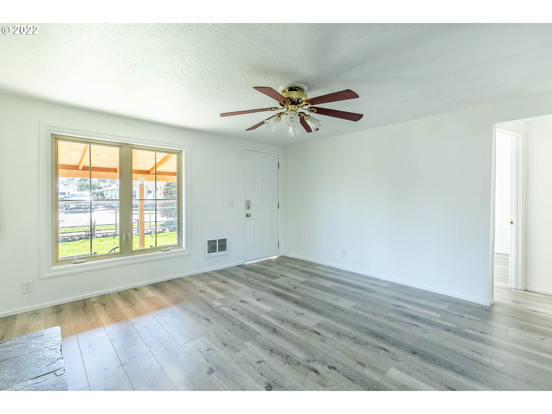 1158 D Street Springfield, OR 97477 - Photo 5 of 24 an empty room with wooden floor and windows