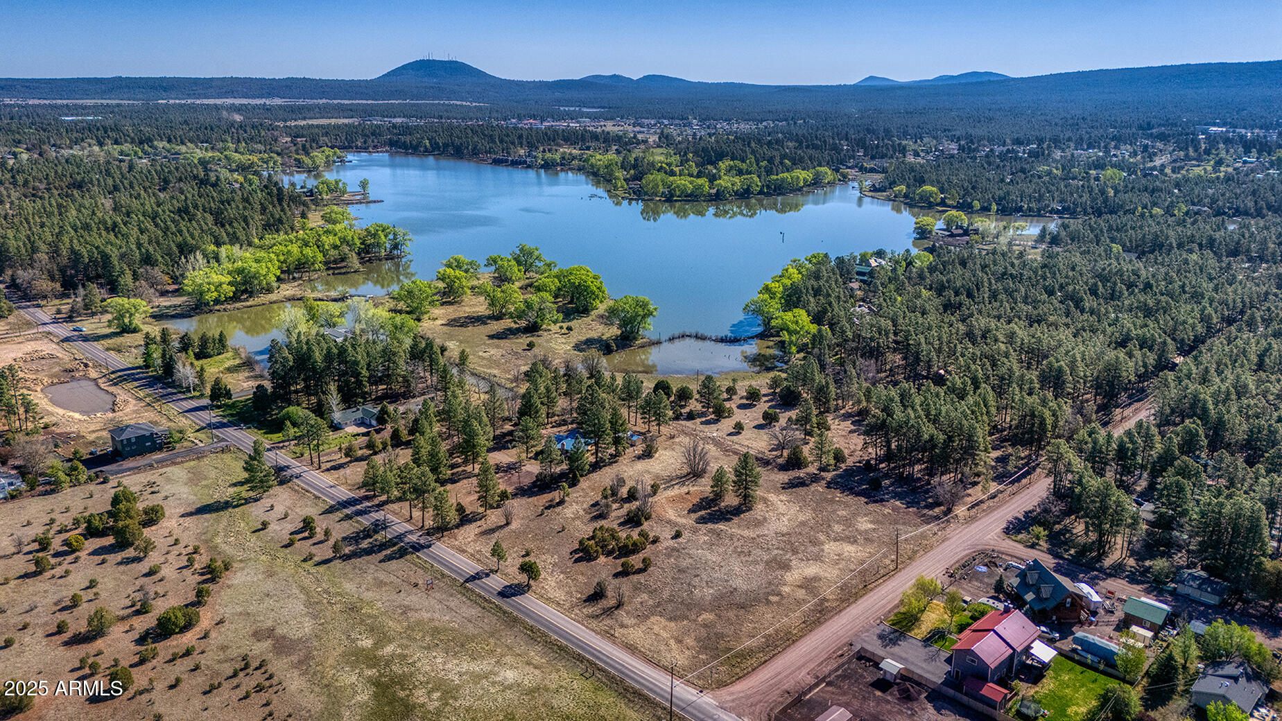 Pinetop-lakeside Larson Road Lakeside, AZ 85929 - Photo 6 of 45 a view of a lake with a mountain in the background