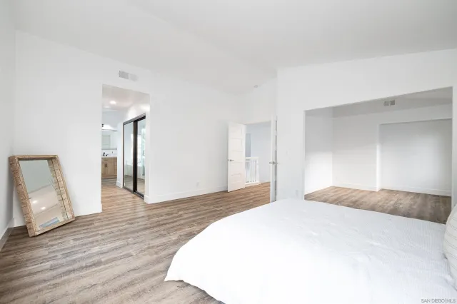 a view of an empty room and wooden floor