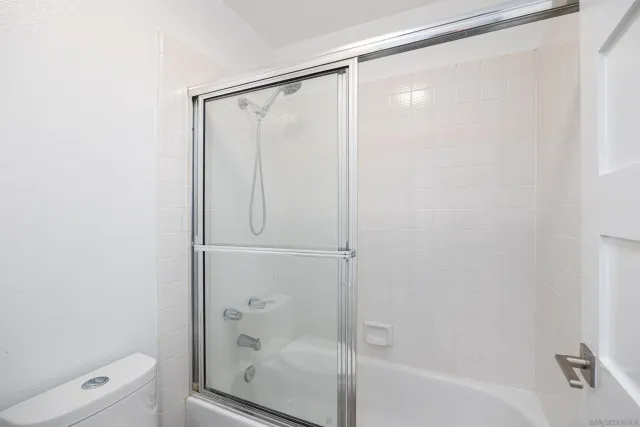 a bathroom with a shower and a toilet
