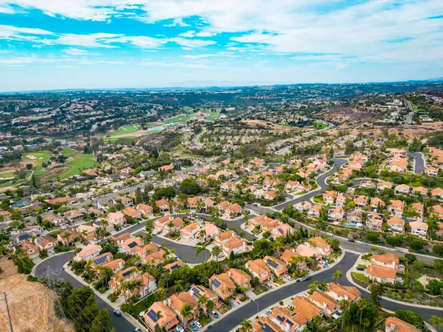 an aerial view of residential building and ocean