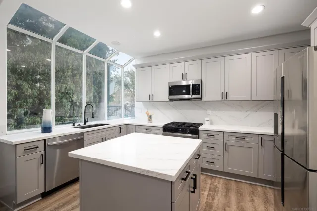 a kitchen with a sink a stove and a refrigerator