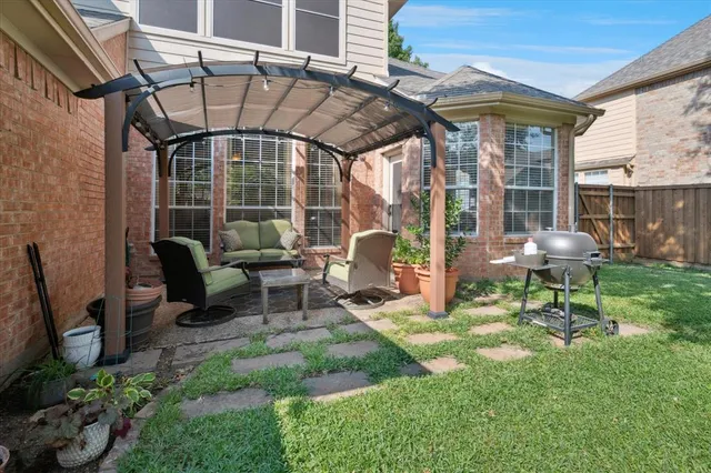 a backyard of a house with table and chairs