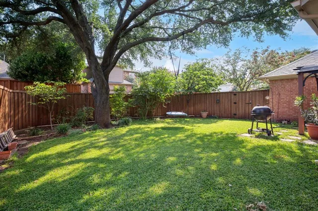 a backyard of a house with table and chairs
