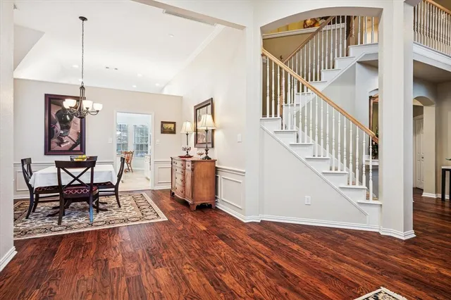 a view of a hallway with wooden floor and furniture