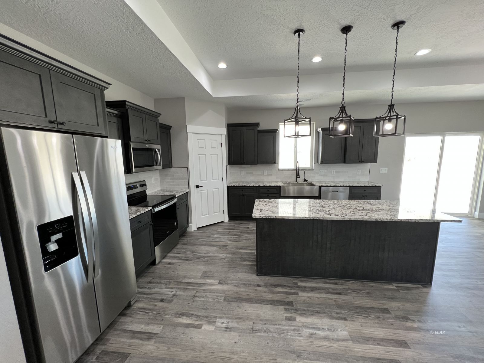 1265 Sun Vly Road Spring Creek, NV 89815 - Photo 2 of 34 a view of kitchen with stainless steel appliances kitchen island granite countertop a refrigerator a stove top oven a sink and dishwasher