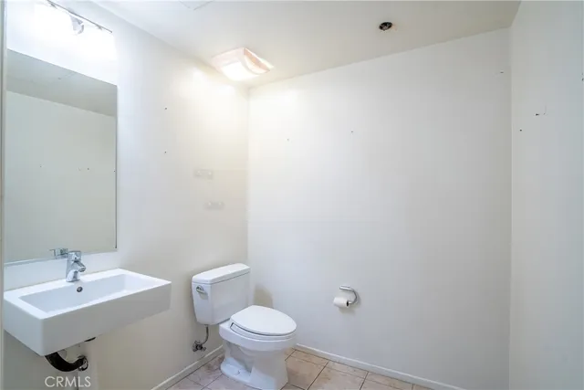 a bathroom with a sink mirror and a toilet