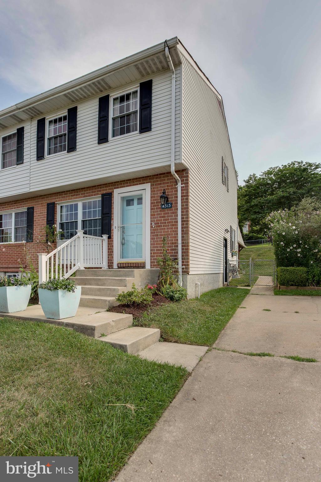 4313 Slater Avenue Baltimore, MD 21236 - Photo 2 of 29 a front view of a house with garden