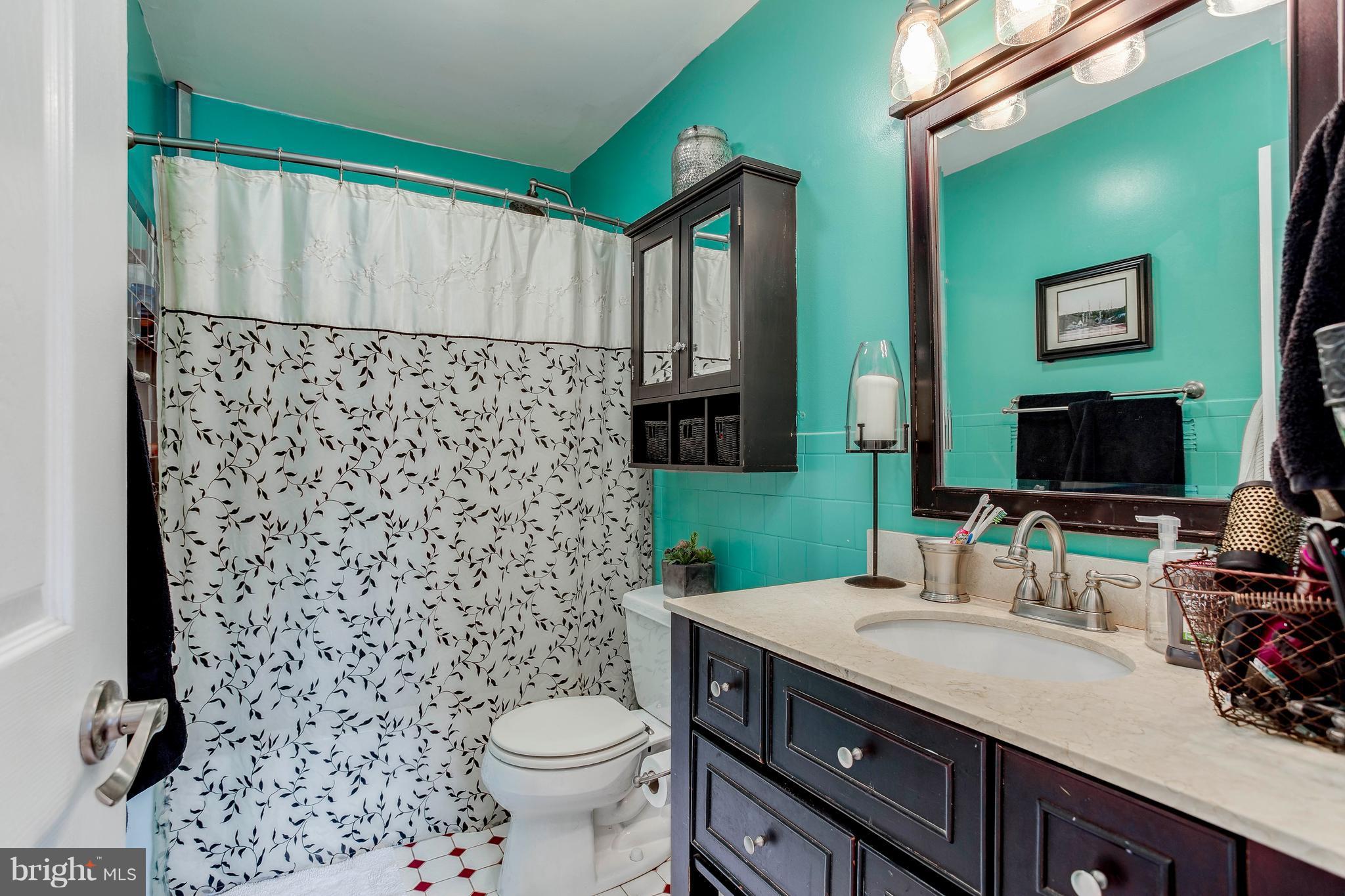4313 Slater Avenue Baltimore, MD 21236 - Photo 20 of 29 a bathroom with a granite countertop toilet sink and mirror