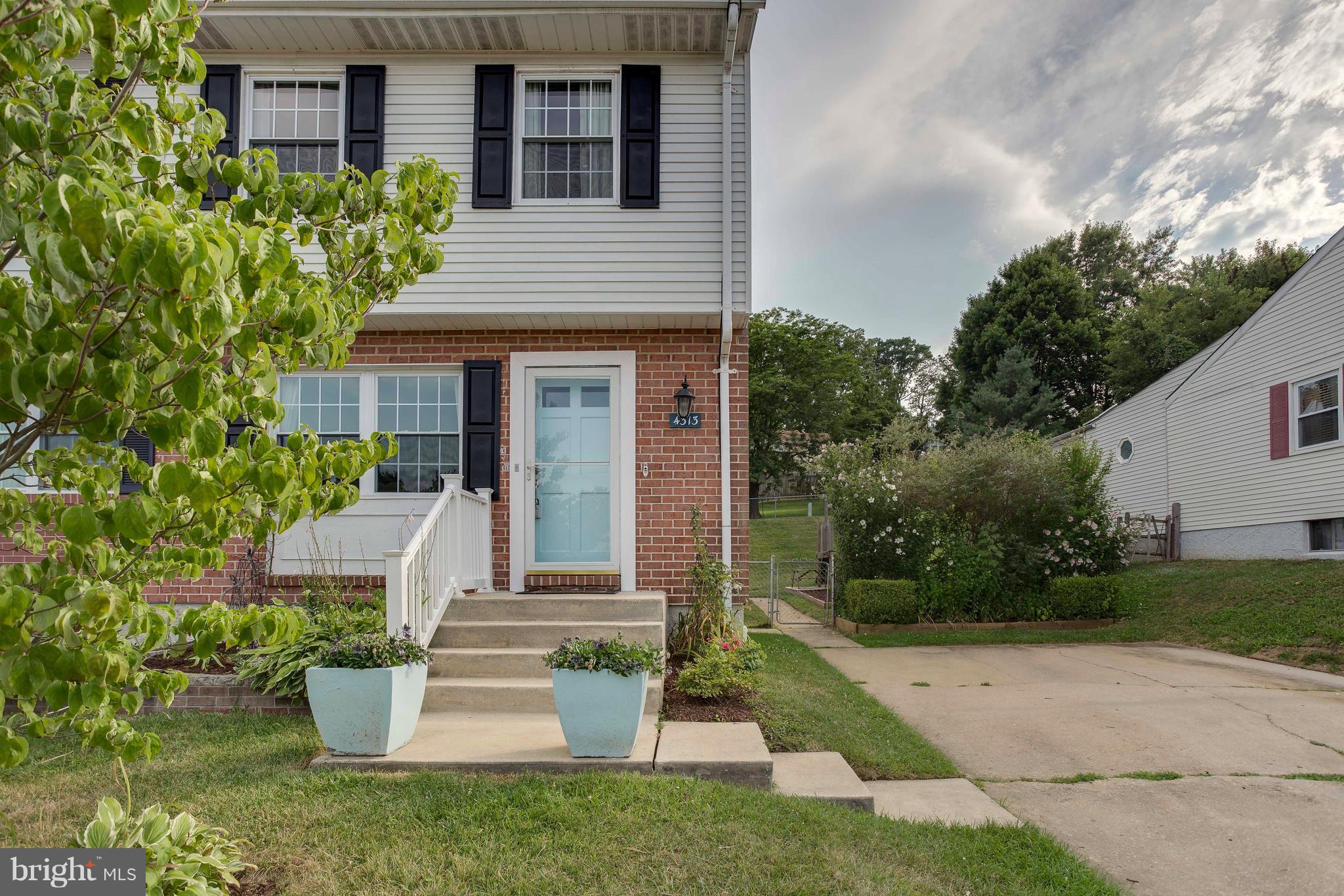 4313 Slater Avenue Baltimore, MD 21236 - Photo 3 of 29 a front view of a house with garden