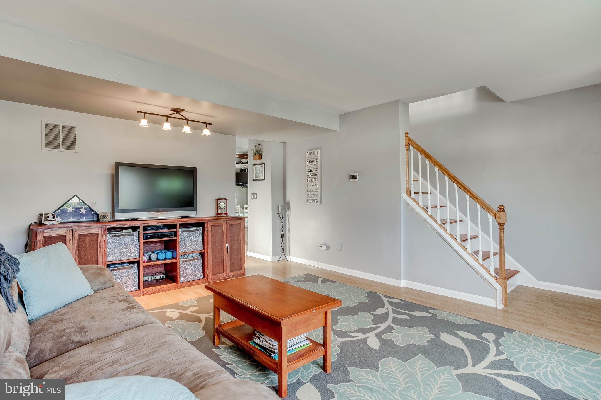 4313 Slater Avenue Baltimore, MD 21236 - Photo 6 of 29 a living room with furniture and a flat screen tv