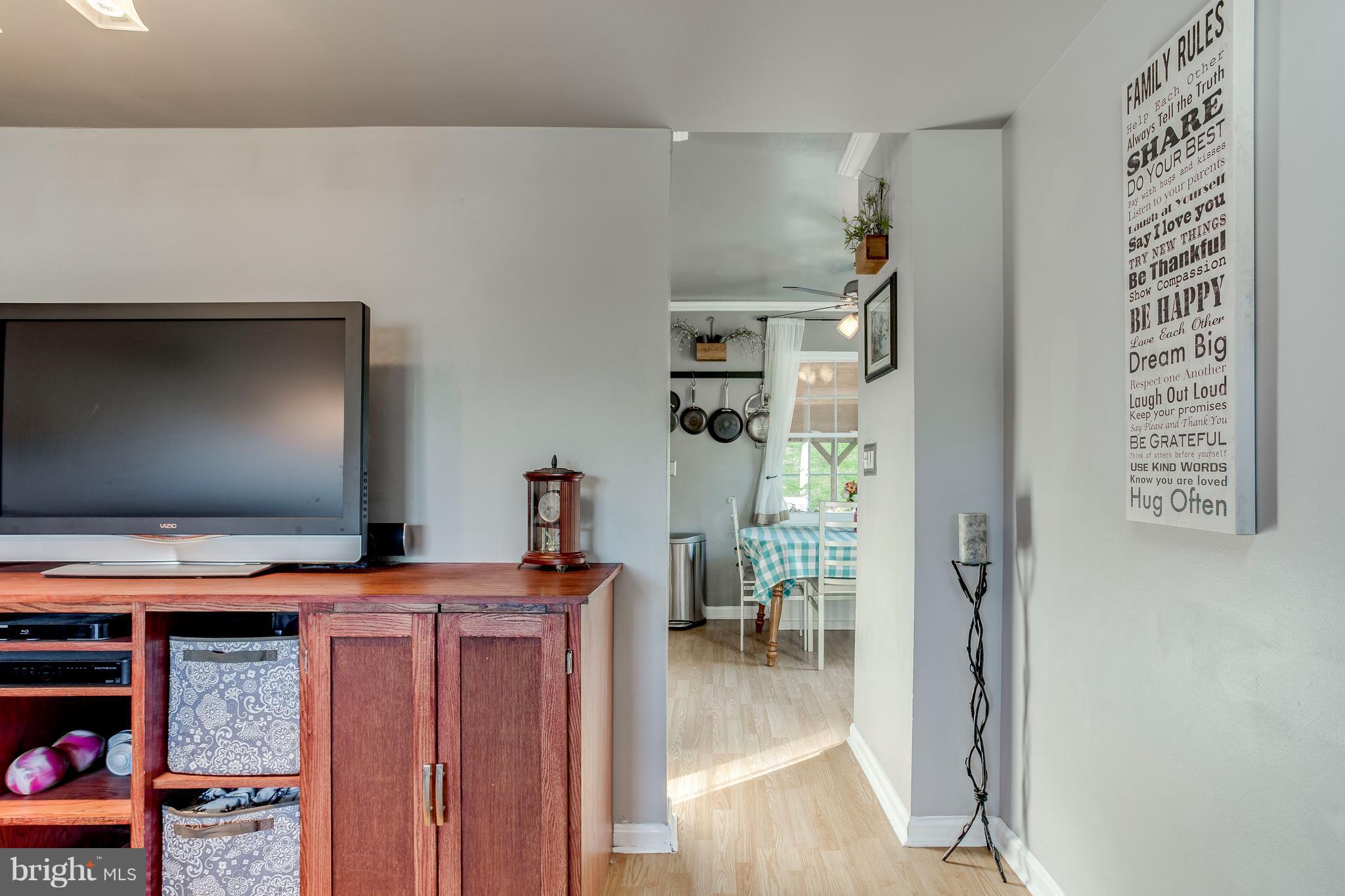 4313 Slater Avenue Baltimore, MD 21236 - Photo 7 of 29 a room with furniture and a flat screen tv