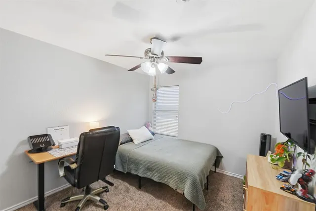 a bedroom with a workspace