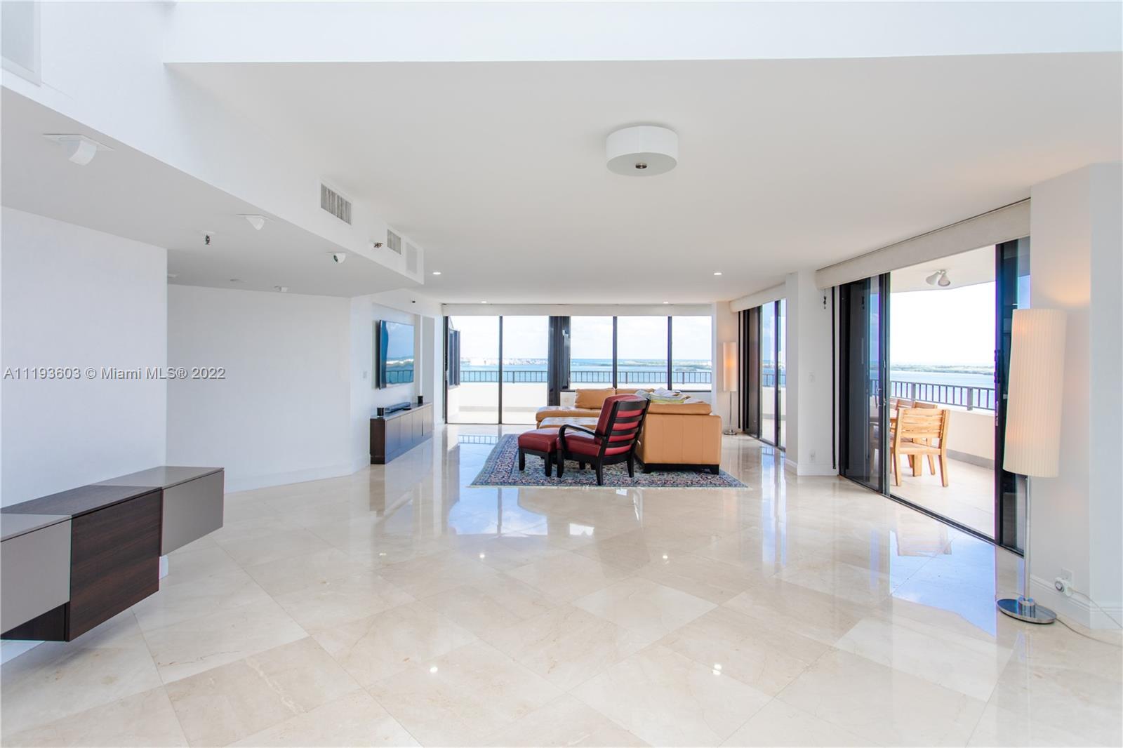 520 Brickell Key Drive, Unit PH03 Miami, FL 33131 - Photo 12 of 75 a living room with furniture and a large window