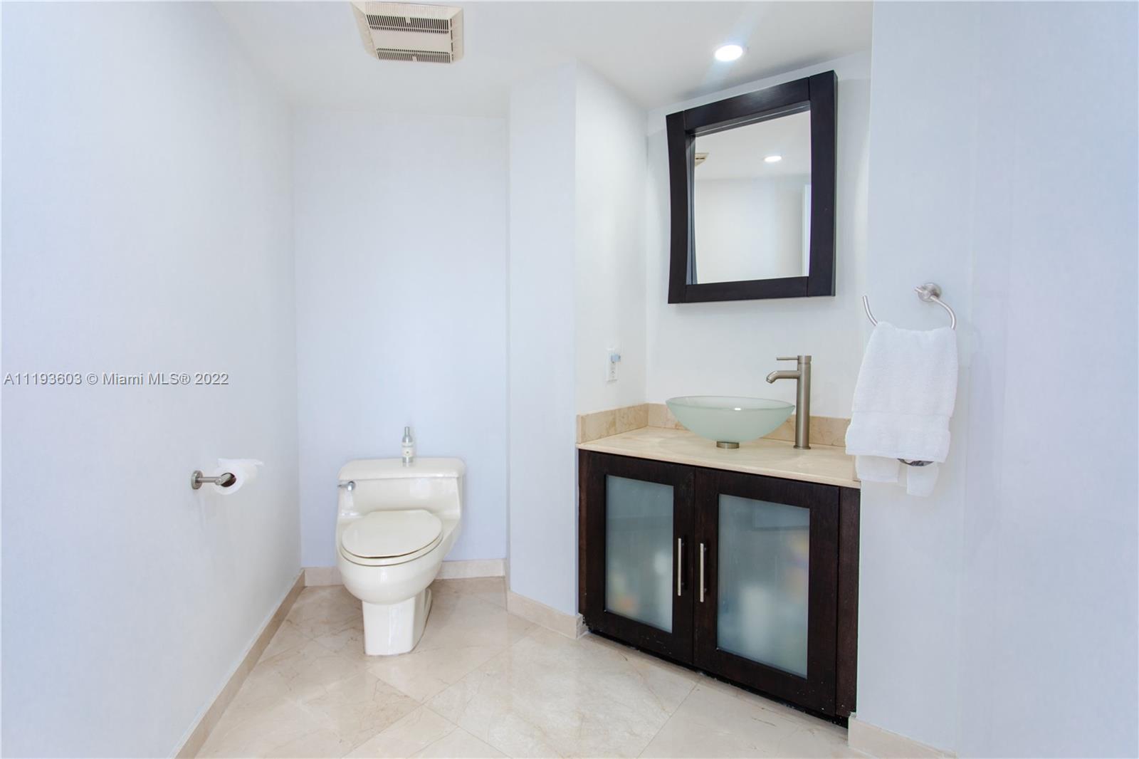 520 Brickell Key Drive, Unit PH03 Miami, FL 33131 - Photo 21 of 75 a bathroom with a toilet sink and mirror