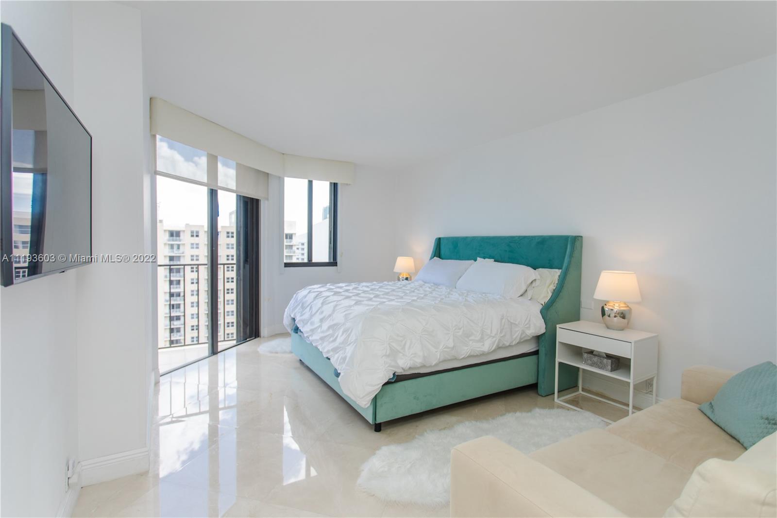 520 Brickell Key Drive, Unit PH03 Miami, FL 33131 - Photo 23 of 75 a spacious bedroom with a bed table and chair