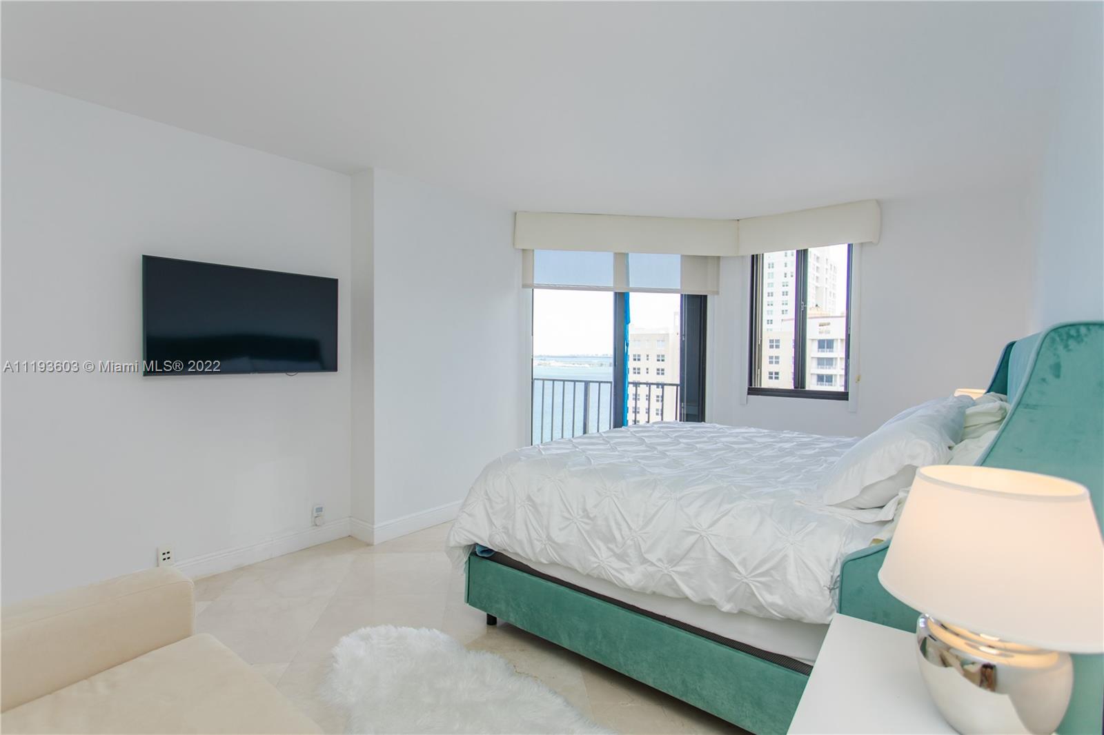520 Brickell Key Drive, Unit PH03 Miami, FL 33131 - Photo 24 of 75 a bedroom with a bed and a flat screen tv