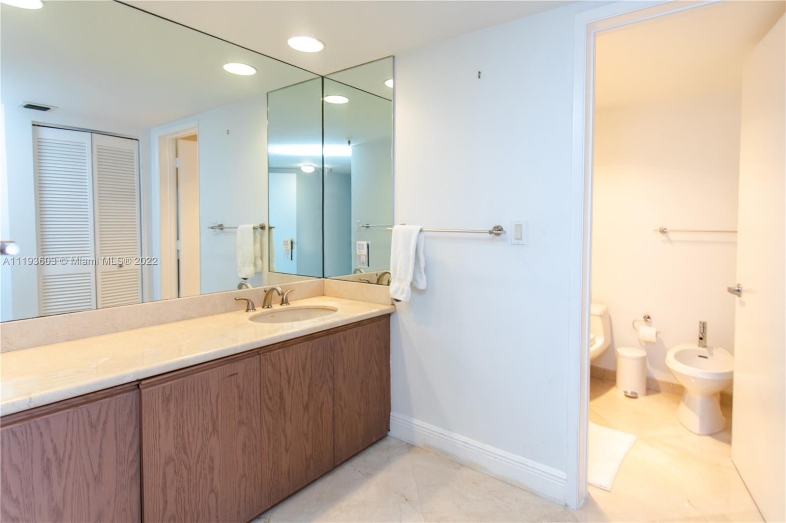 520 Brickell Key Drive, Unit PH03 Miami, FL 33131 - Photo 26 of 75 a bathroom with a sink and a mirror