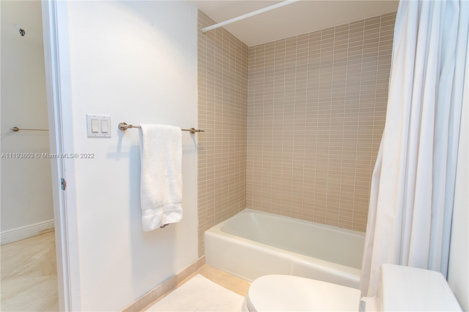 520 Brickell Key Drive, Unit PH03 Miami, FL 33131 - Photo 27 of 75 a bathroom with a bathtub and a shower