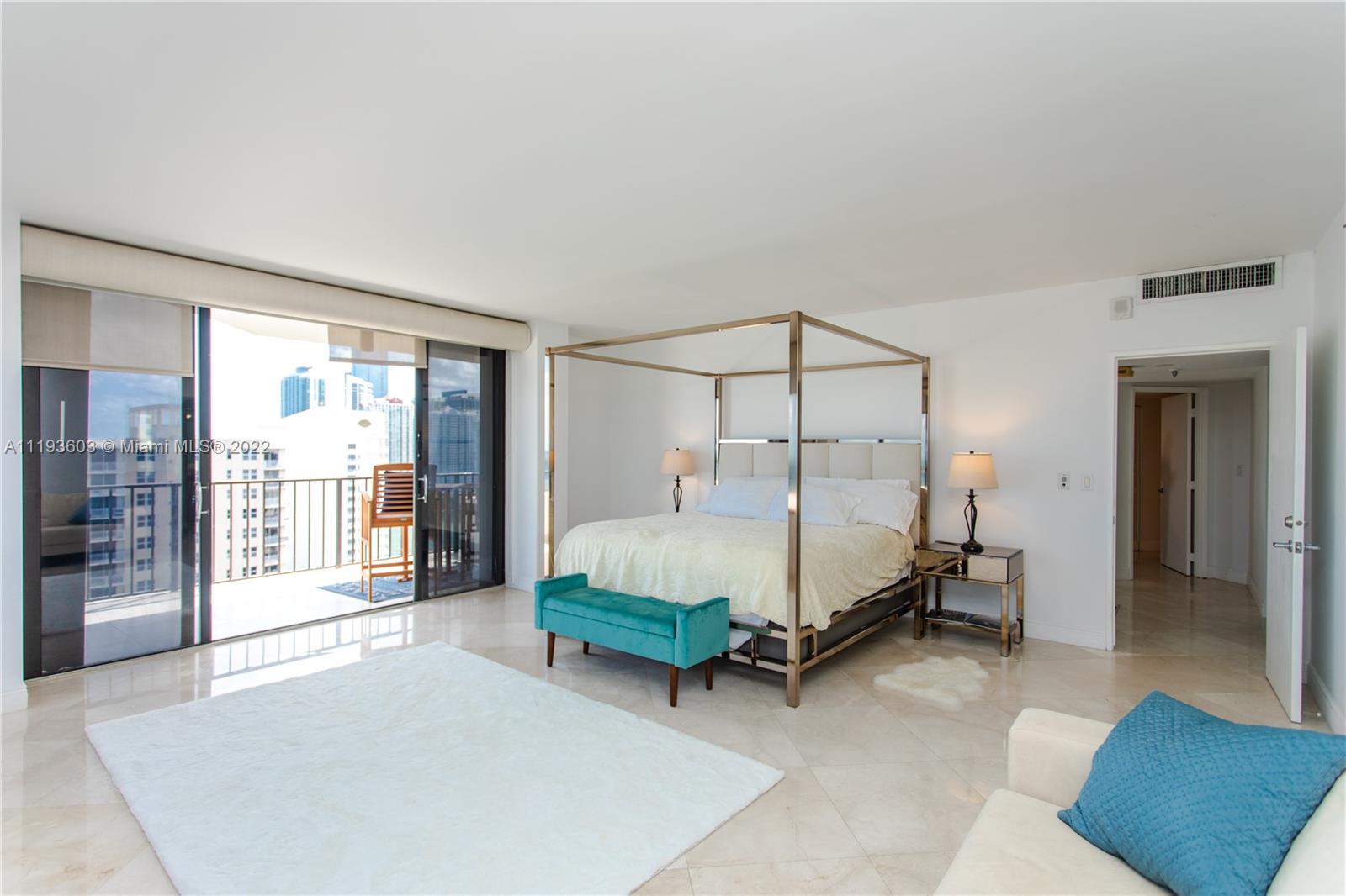 520 Brickell Key Drive, Unit PH03 Miami, FL 33131 - Photo 38 of 75 a bed sitting in a spacious bedroom next to a window