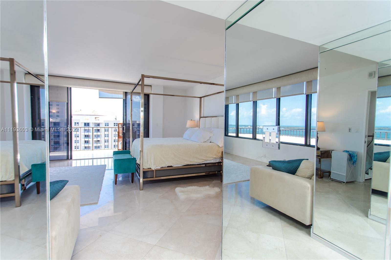 520 Brickell Key Drive, Unit PH03 Miami, FL 33131 - Photo 39 of 75 a bedroom with a bed a couch and large window