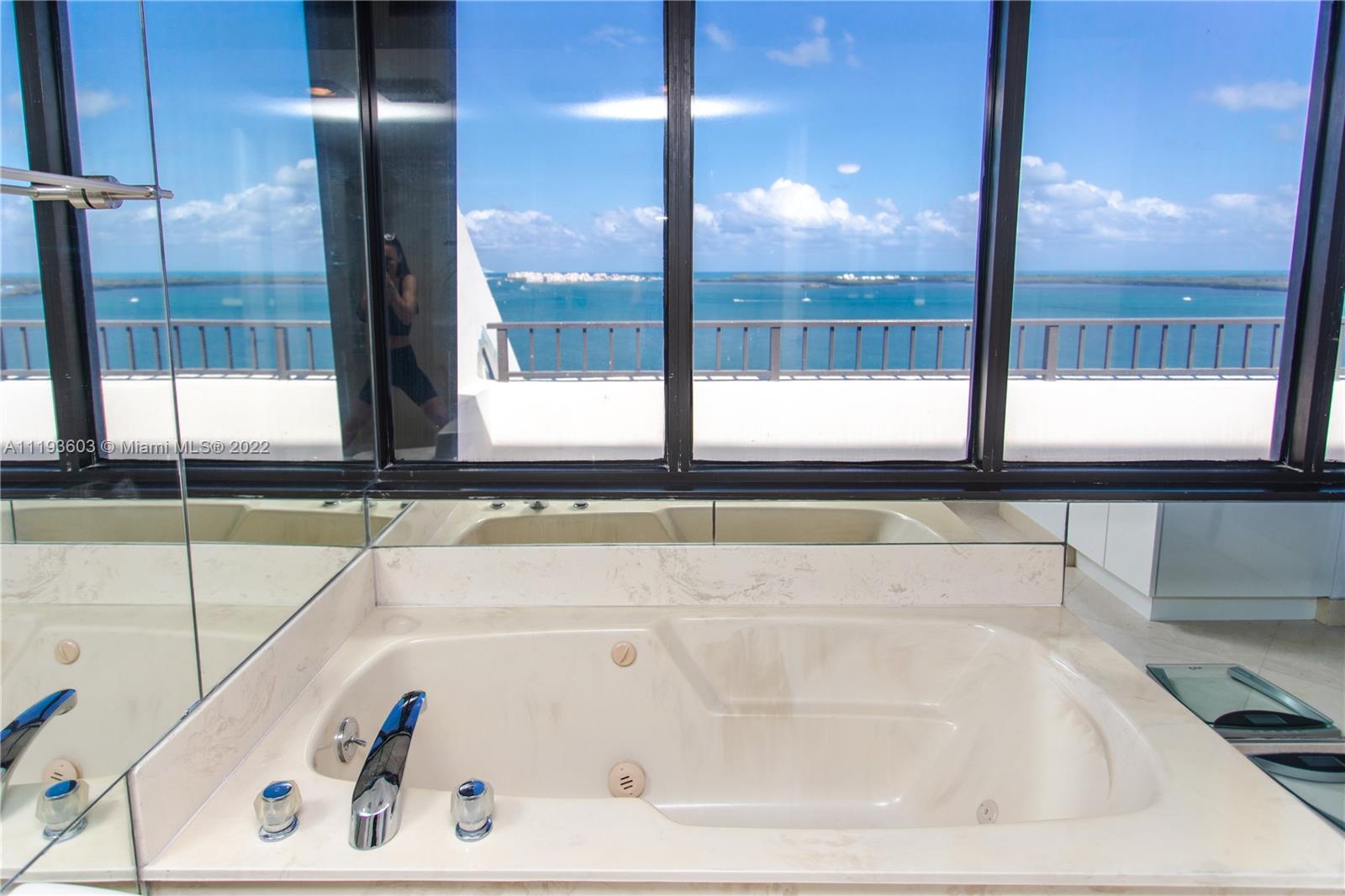 520 Brickell Key Drive, Unit PH03 Miami, FL 33131 - Photo 47 of 75 a bathroom with a bathtub and next to a window