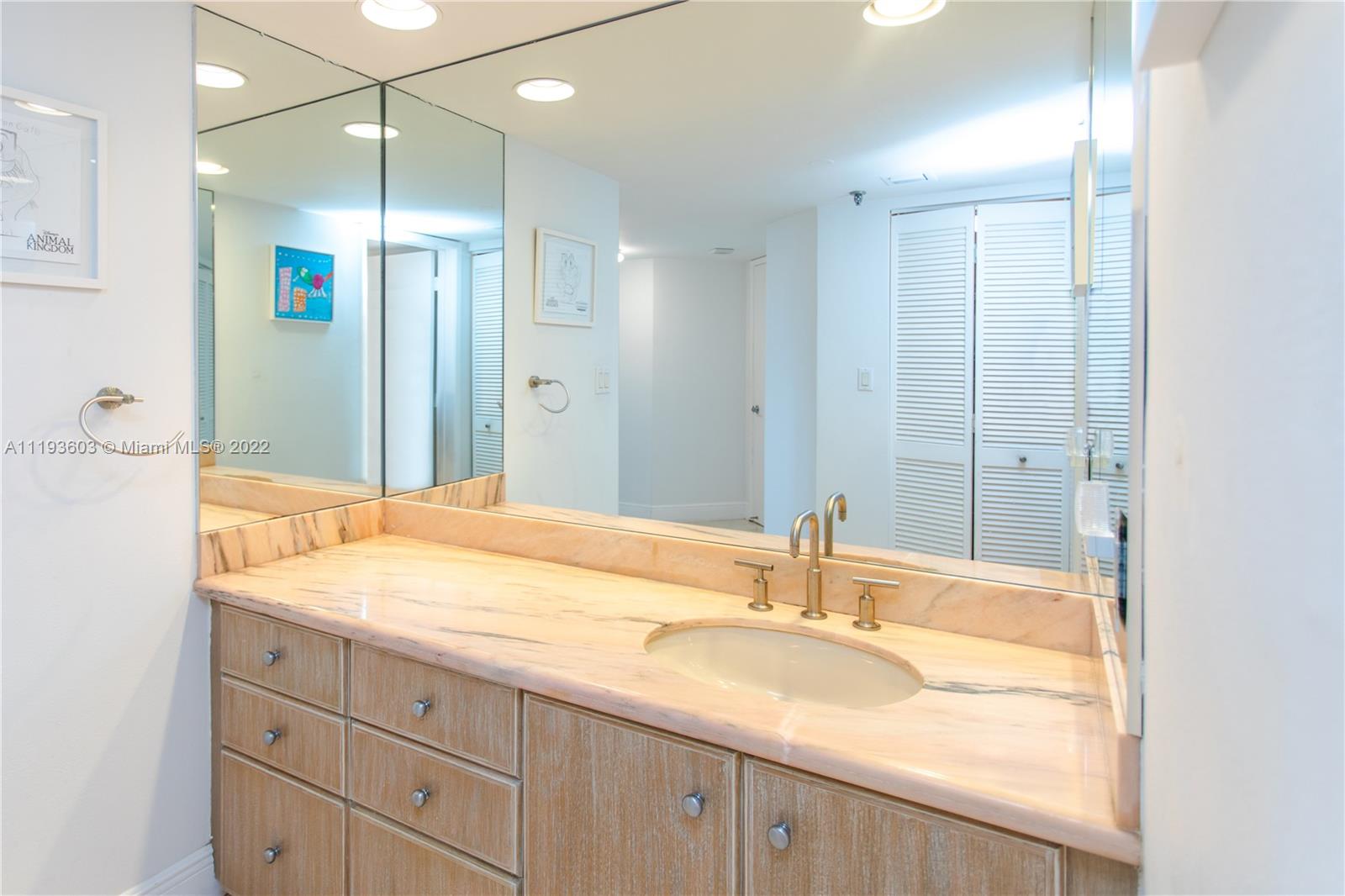 520 Brickell Key Drive, Unit PH03 Miami, FL 33131 - Photo 50 of 75 a bathroom with a granite countertop sink and a large mirror
