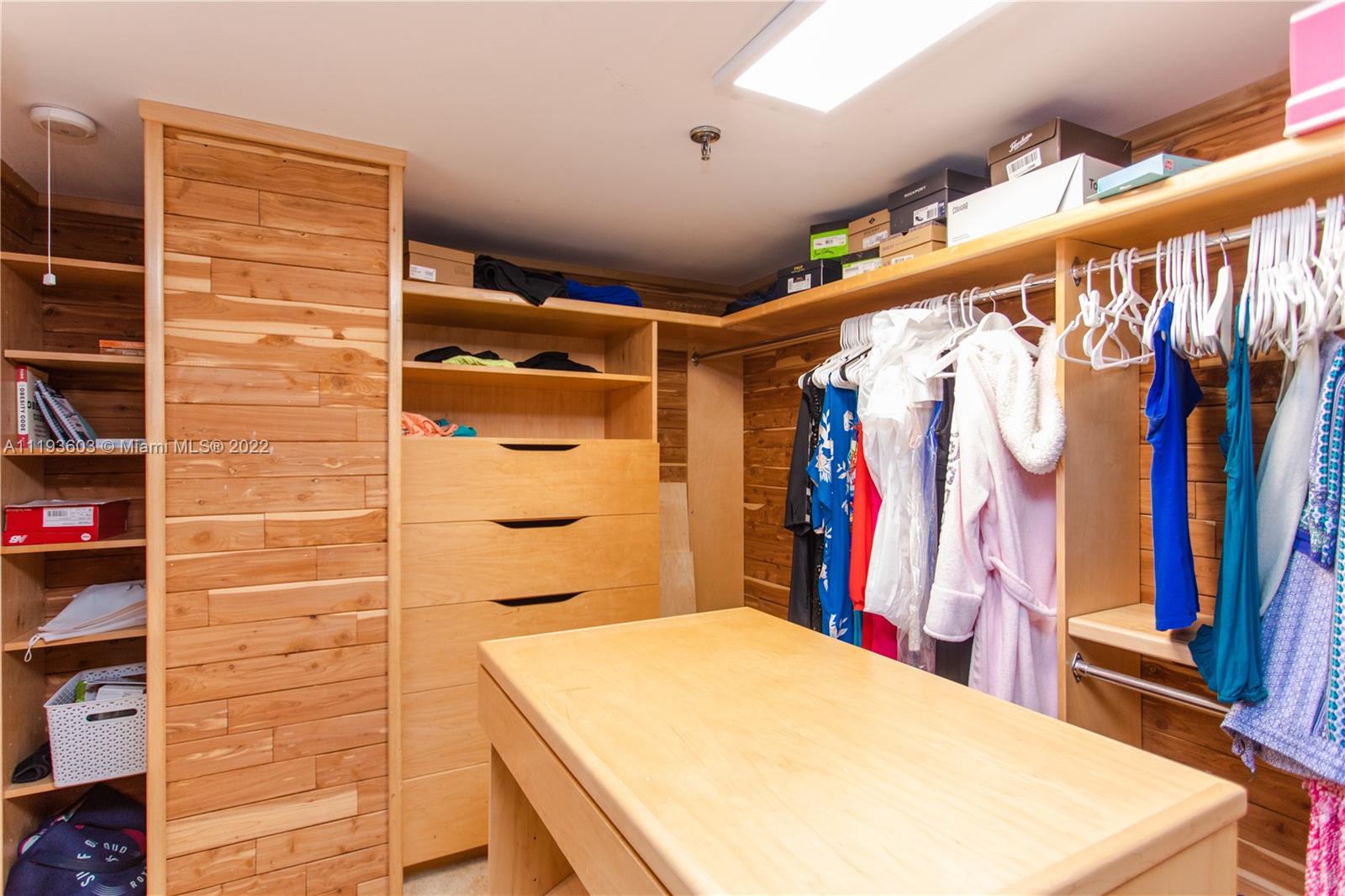 520 Brickell Key Drive, Unit PH03 Miami, FL 33131 - Photo 53 of 75 a view of walk in closet with clothes and shoes