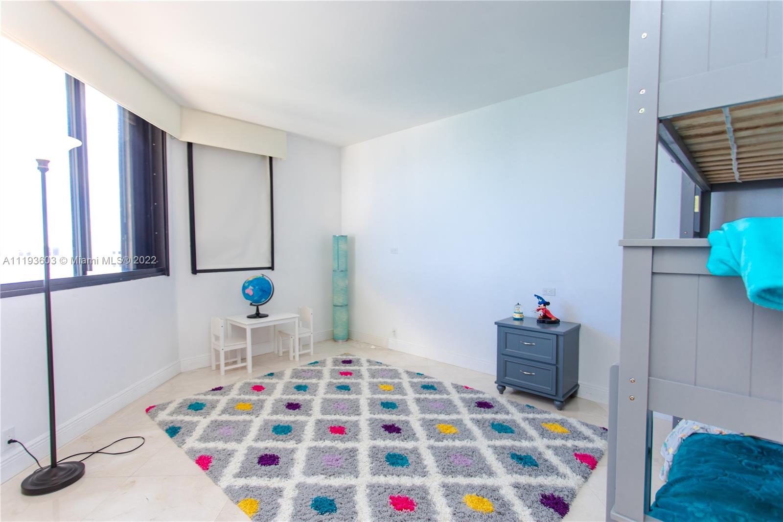 520 Brickell Key Drive, Unit PH03 Miami, FL 33131 - Photo 59 of 75 a room that has a baby crib and a chair in it