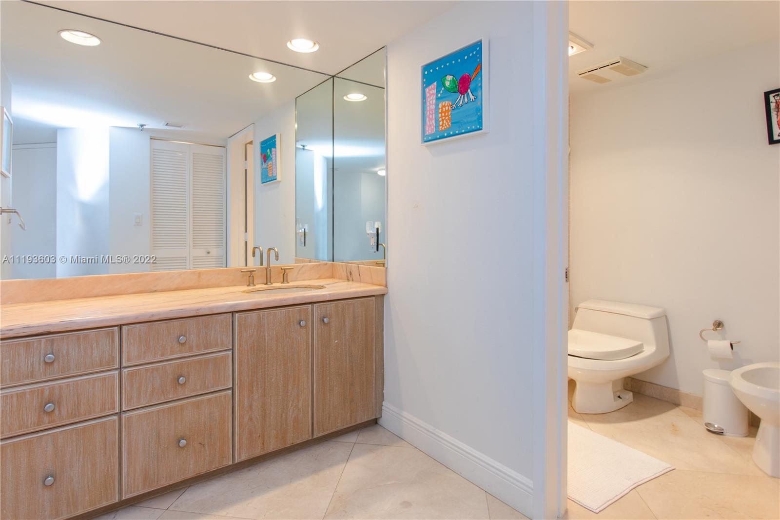 520 Brickell Key Drive, Unit PH03 Miami, FL 33131 - Photo 60 of 75 a spacious bathroom with a granite countertop sink a toilet and a mirror
