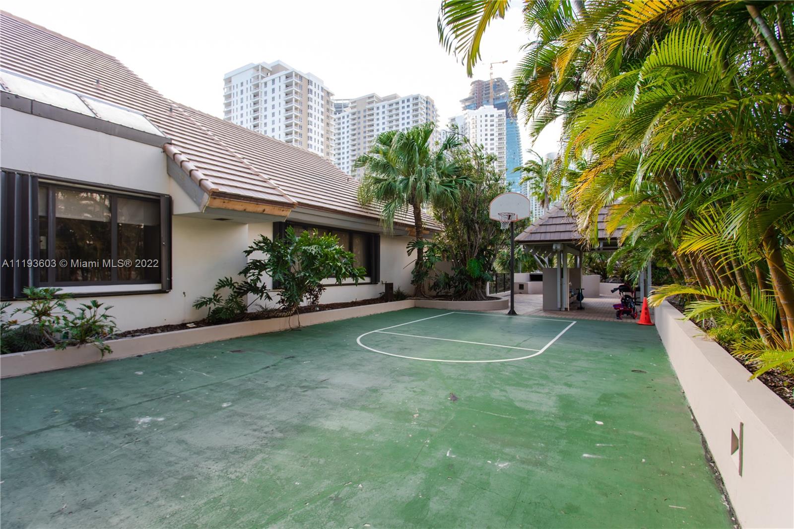 520 Brickell Key Drive, Unit PH03 Miami, FL 33131 - Photo 68 of 75 a view of a house with a yard and a patio