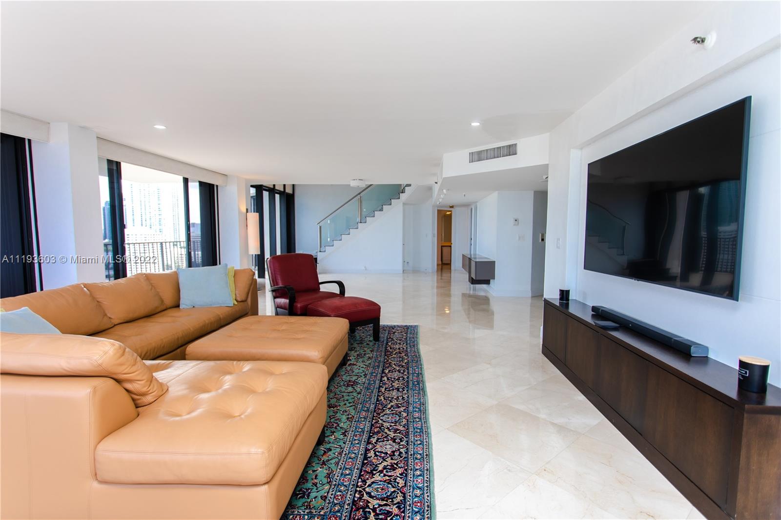 520 Brickell Key Drive, Unit PH03 Miami, FL 33131 - Photo 8 of 75 a living room with furniture fireplace and flat screen tv
