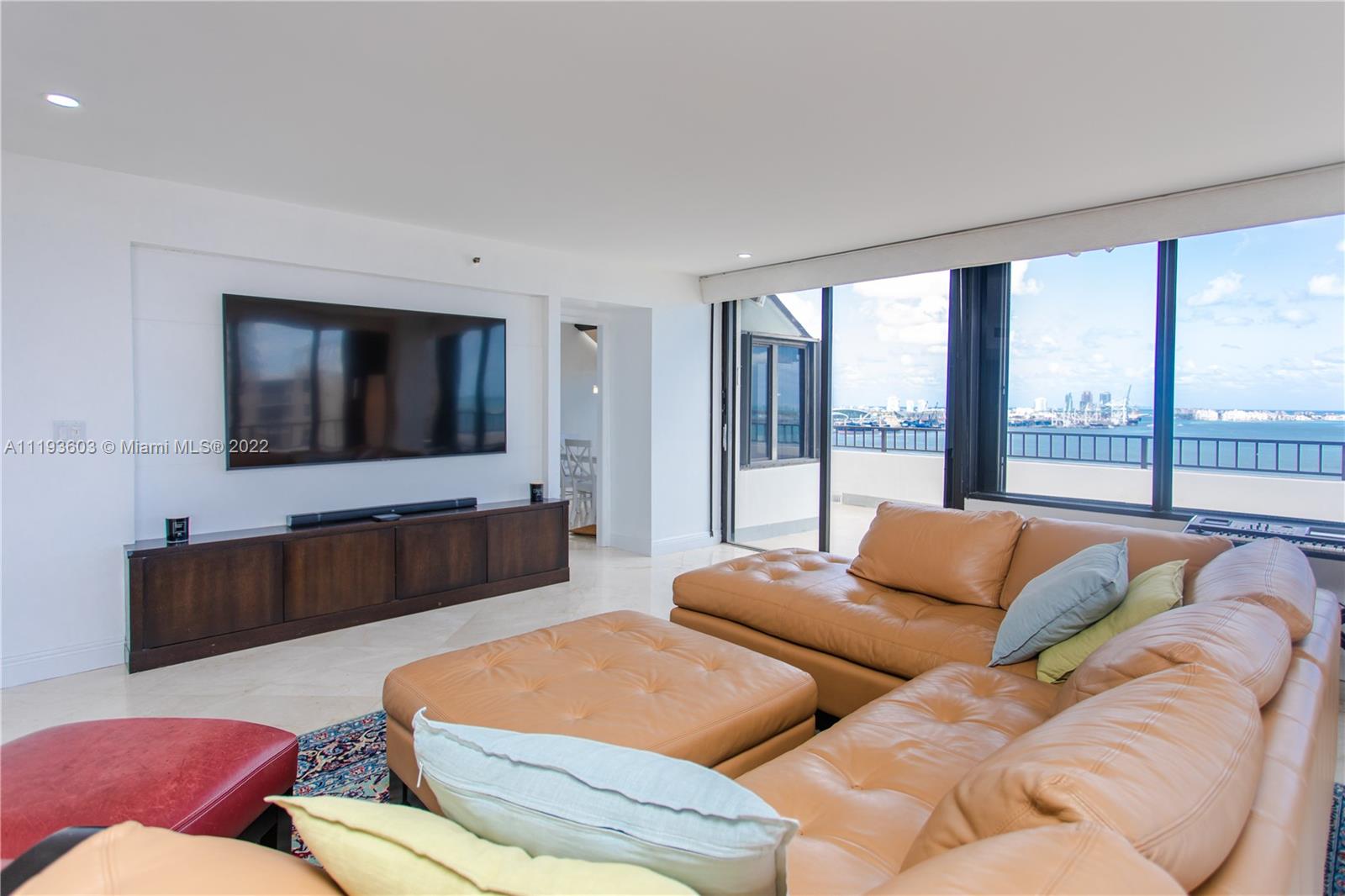 520 Brickell Key Drive, Unit PH03 Miami, FL 33131 - Photo 9 of 75 a living room with couches and a flat screen tv