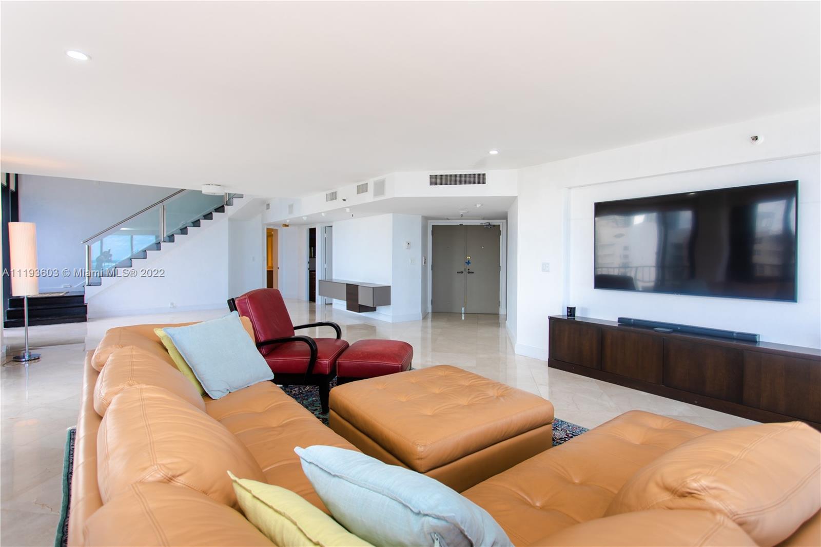 520 Brickell Key Drive, Unit PH03 Miami, FL 33131 - Photo 10 of 75 a living room with furniture and a flat screen tv