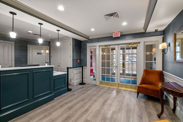 a lobby with furniture and a potted plant