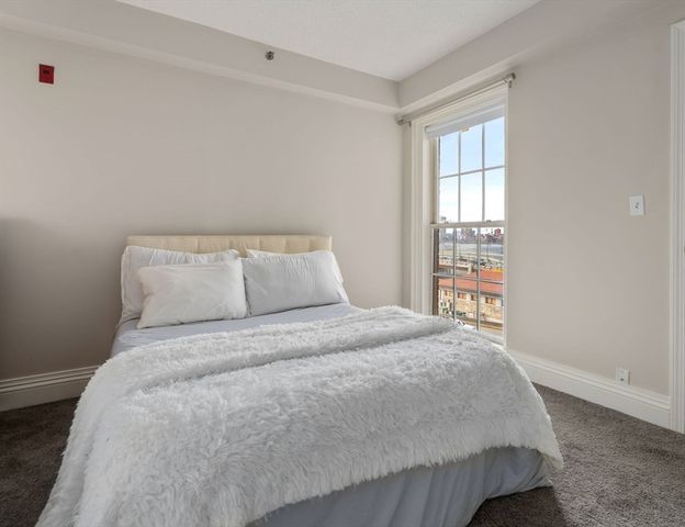 a bedroom with a bed and a window