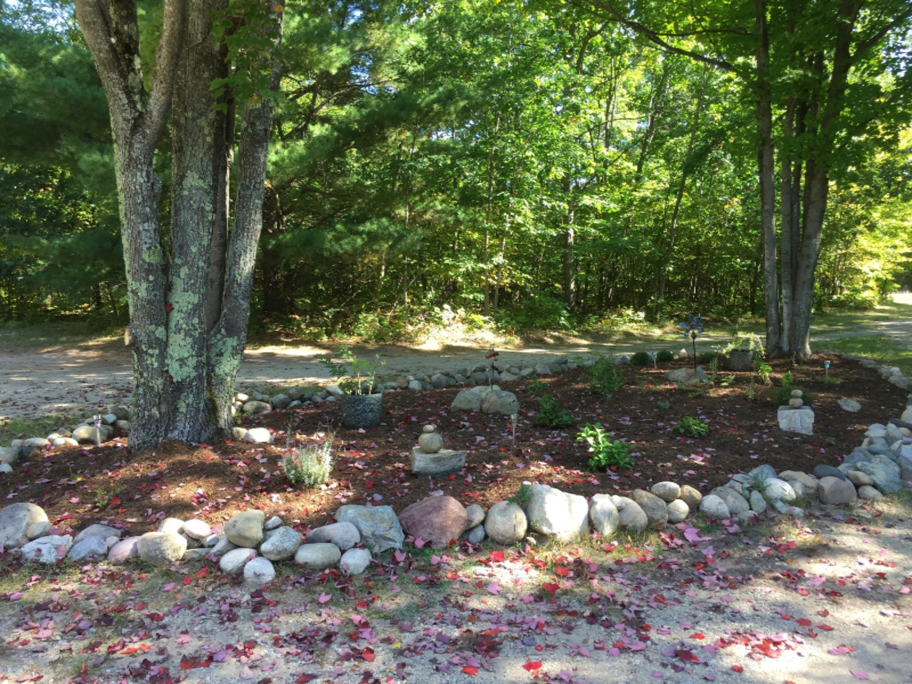 7040 North High Bridge Road Kaleva, MI 49645 - Photo 49 of 50 Great landscaping in circle driveway