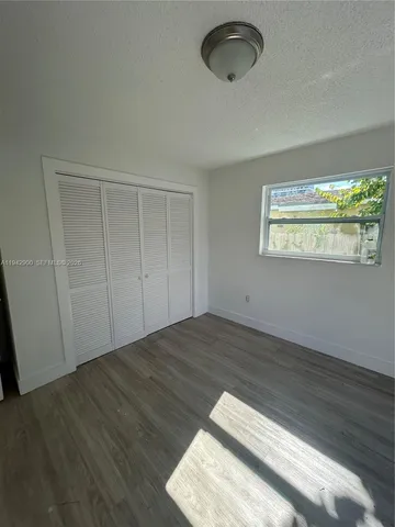 a view of a room with wooden floor and natural light
