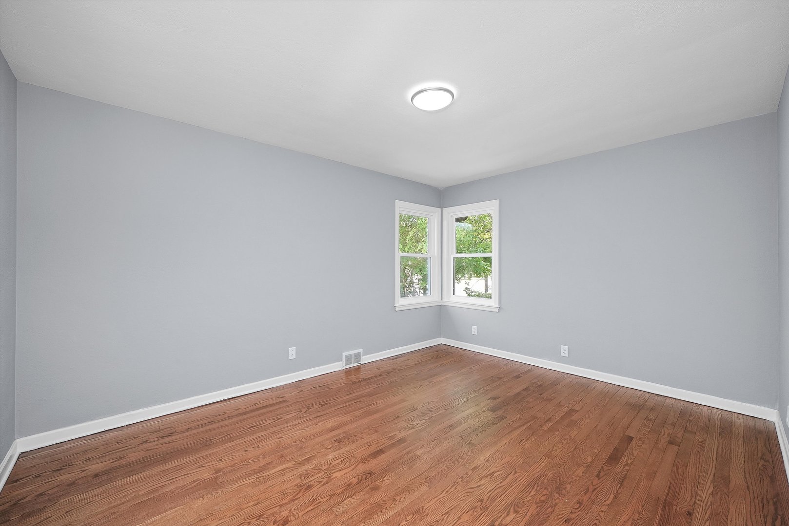 224 South State Street Lockport, IL 60441 - Photo 2 of 28 an empty room with wooden floor and windows