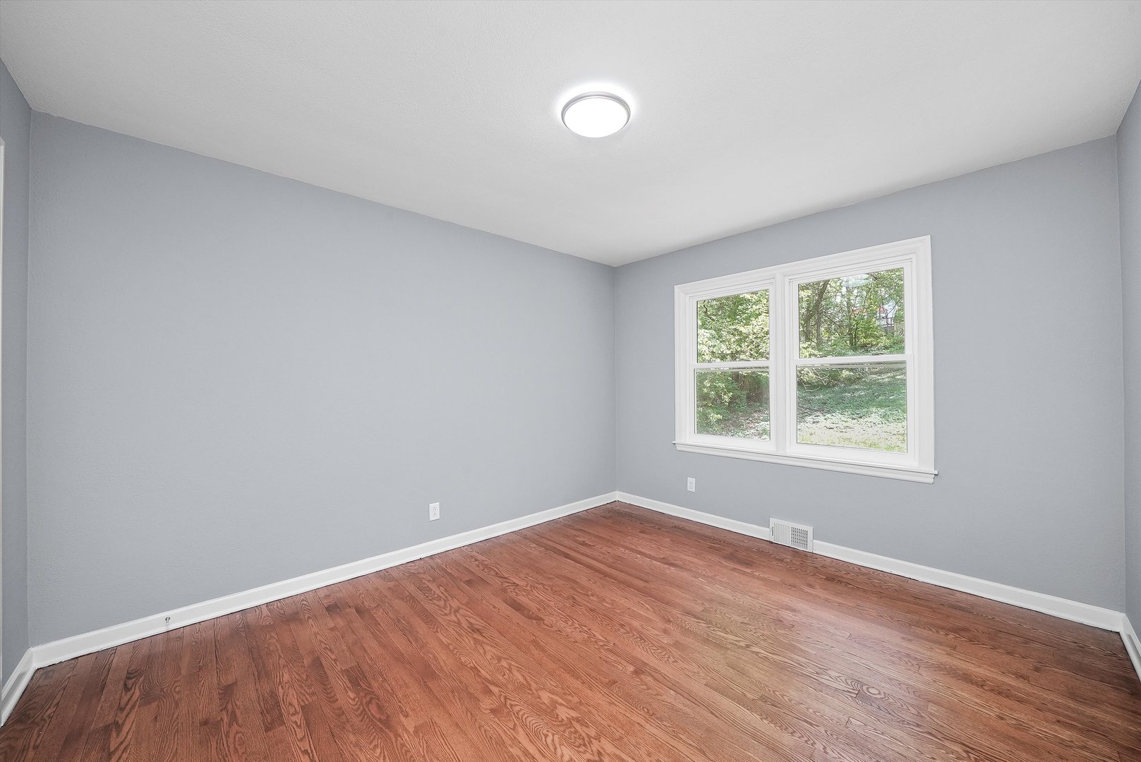 224 South State Street Lockport, IL 60441 - Photo 3 of 28 a view of an empty room with wooden floor and a window