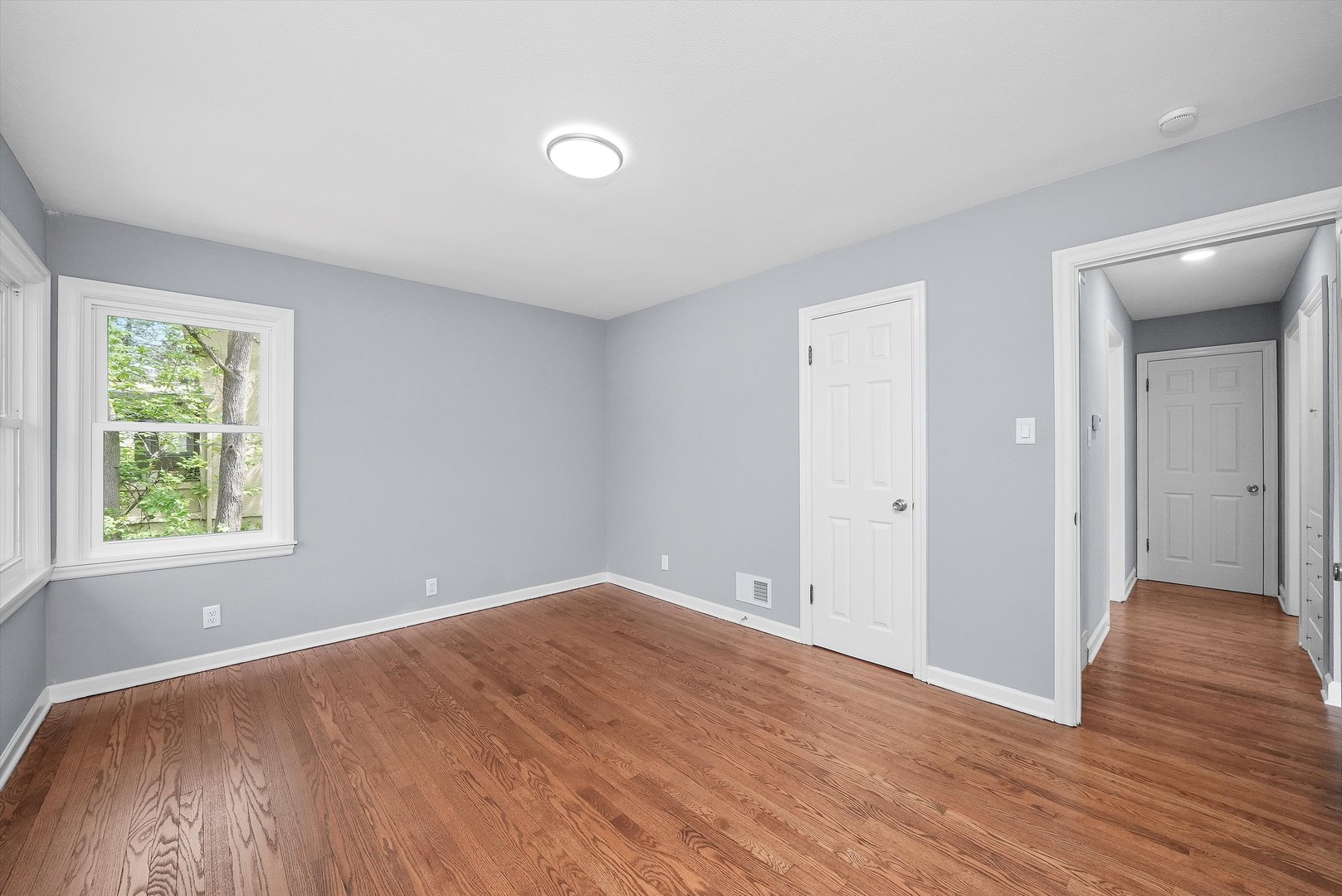 224 South State Street Lockport, IL 60441 - Photo 4 of 28 an empty room with wooden floor and windows