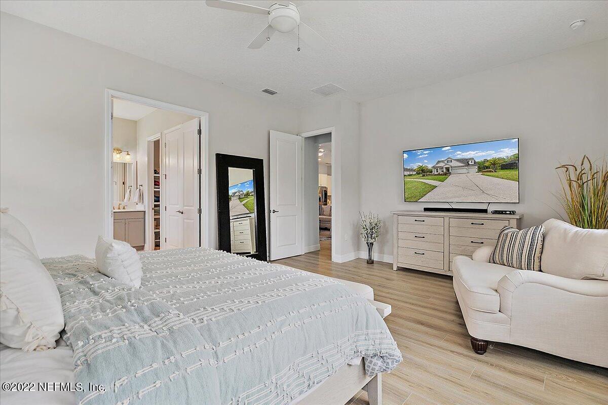 27 Red Twig Way St. Augustine, FL 32092 - Photo 14 of 47 a spacious bedroom with a bed and a couch